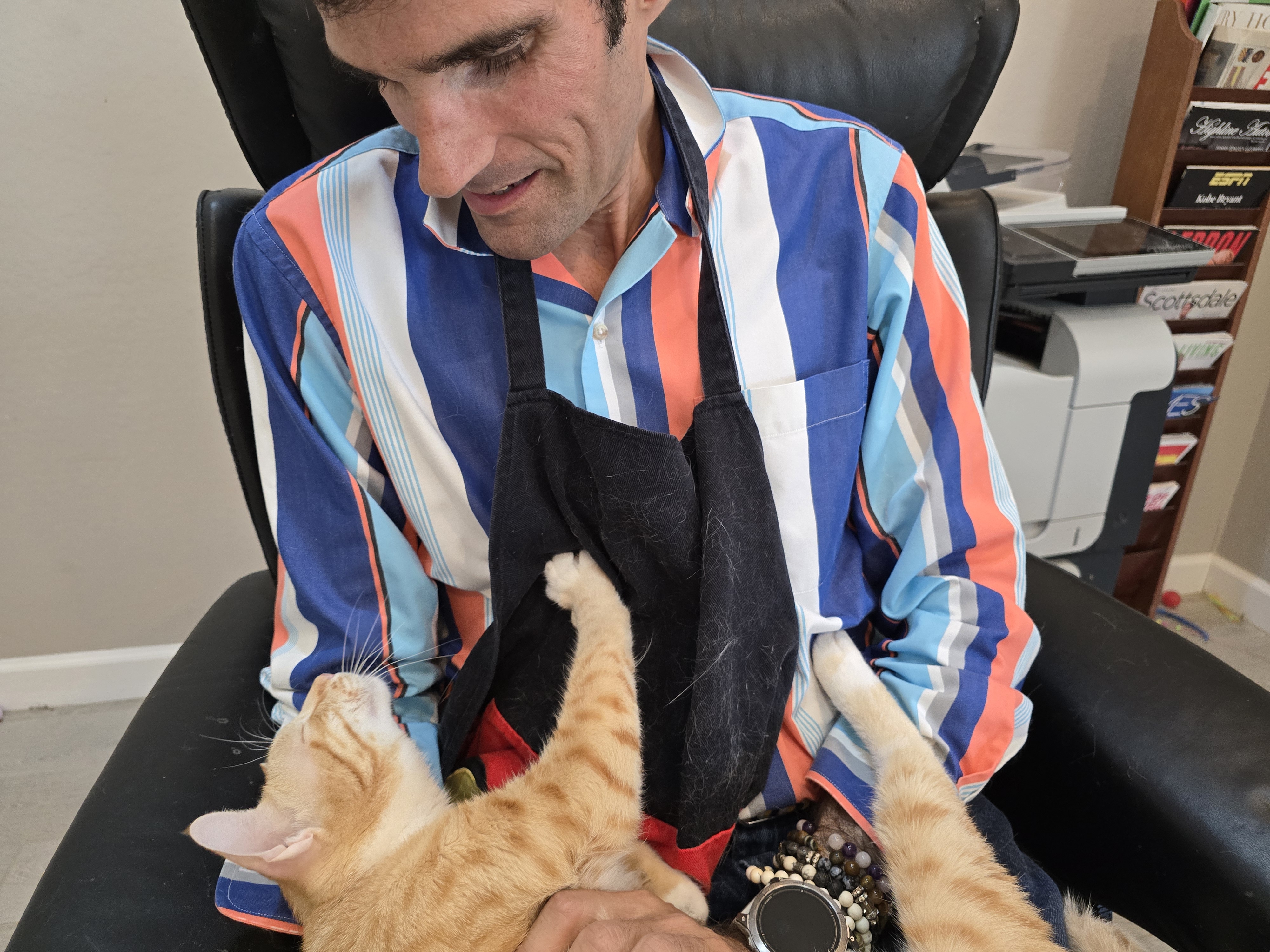 Sascha sharing a loving moment with Amore, an orange cat